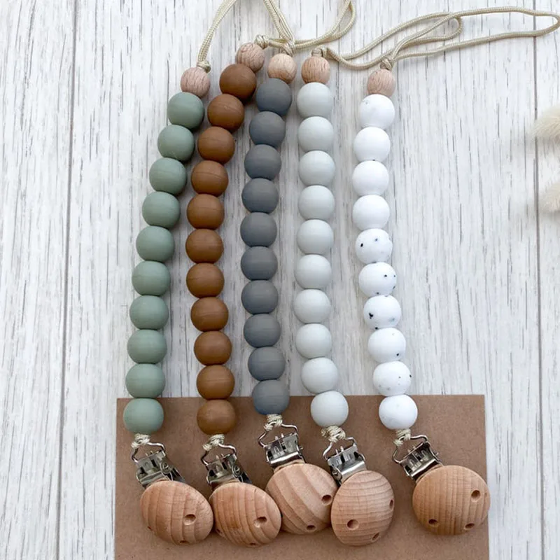 Safety Chewable Silicone Bead Pacifier Holder Baby Food Grade Silicone Wooden Pacifier Clip
Safety Chewable Silicone Bead Pacifier Holder Baby Food Grade Silicone Wooden Pacifier Clip