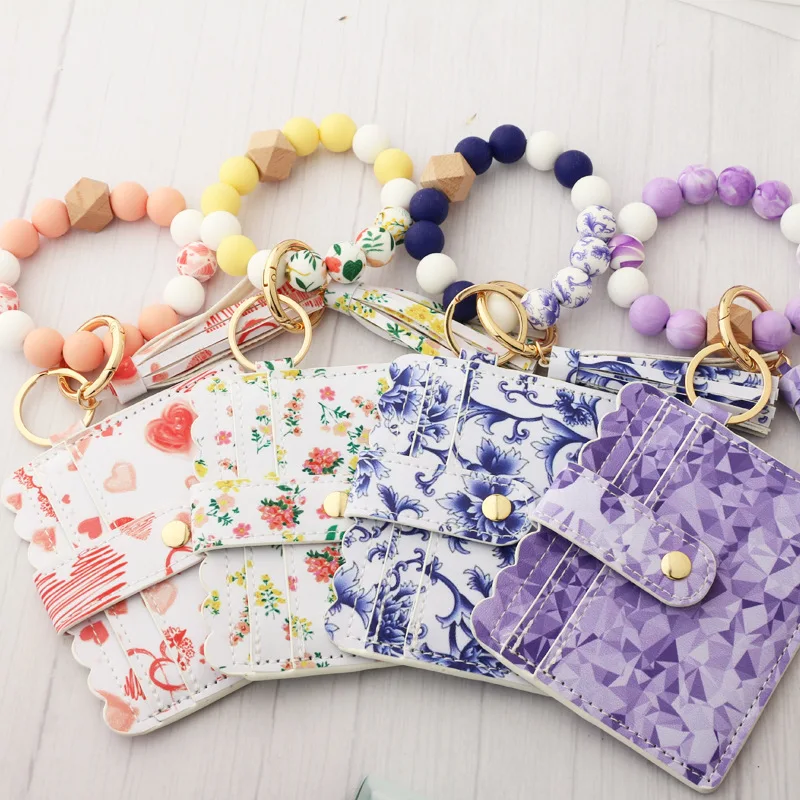 2022 Flower Printing Silicon Beads Bracelet Keychain Pu Leather Tassel Silicon Beads Wristlet Keychain Wallet for Women, Printing designs
2022 Flower Printing Silicon Beads Bracelet Keychain Pu Leather Tassel Silicon Beads Wristlet Keychain Wallet for Women, Printing designs