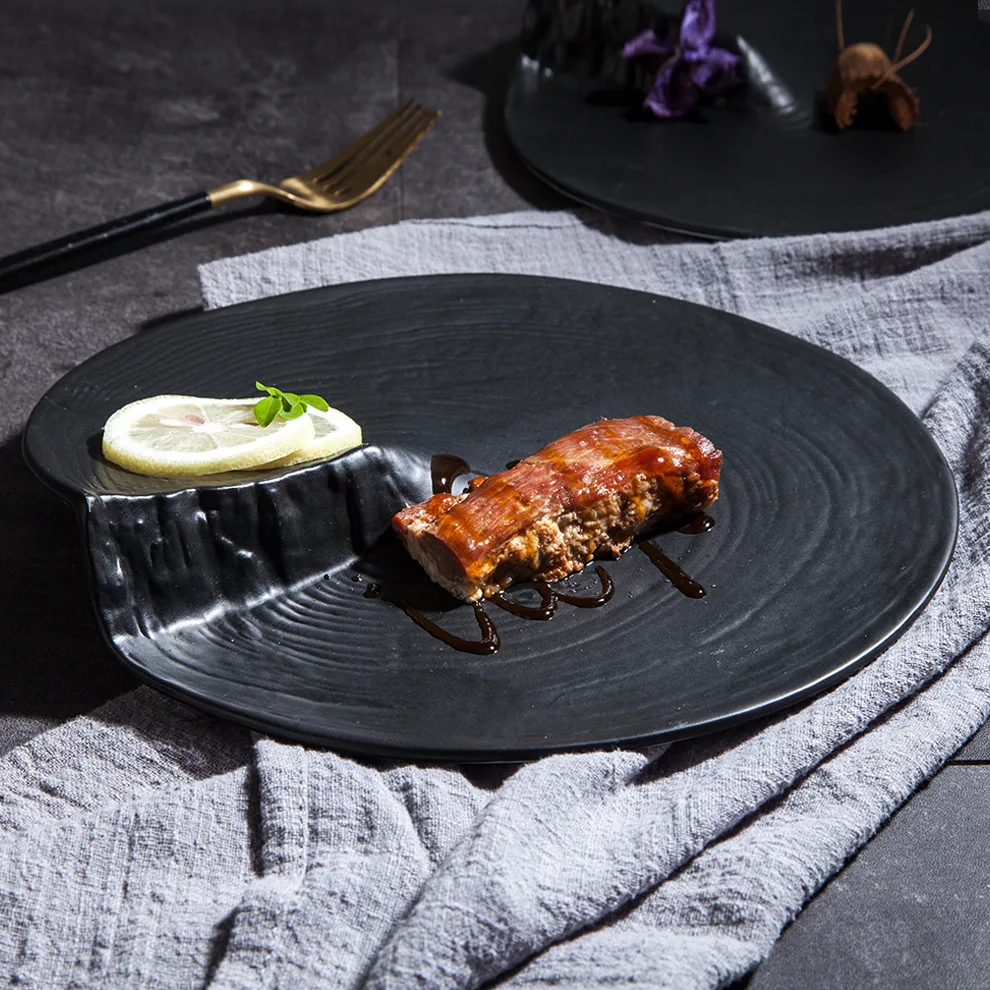 Factory wholesale Japanese irregular ceramic plate creative western steak plate simple black fruit salad plate
Factory wholesale Japanese irregular ceramic plate creative western steak plate simple black fruit salad plate