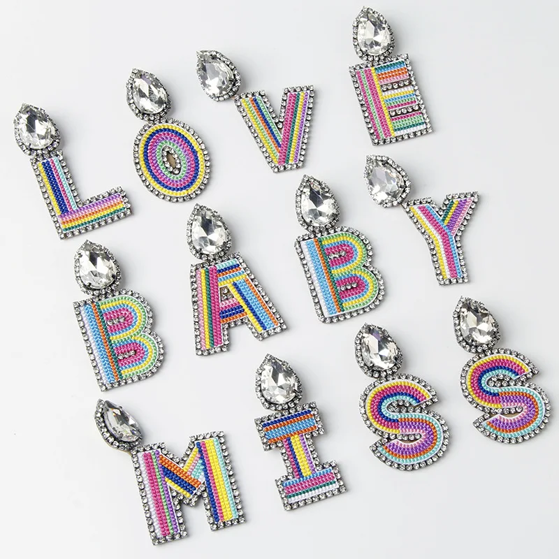 European And American Fashion Bohemia Embroidered Diamond Earrings Women Mixed Color Letter Stud Earrings
European And American Fashion Bohemia Embroidered Diamond Earrings Women Mixed Color Letter Stud Earrings