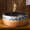 Classic wood color round table top small ceramic hand wash sink basin with dark brown in side