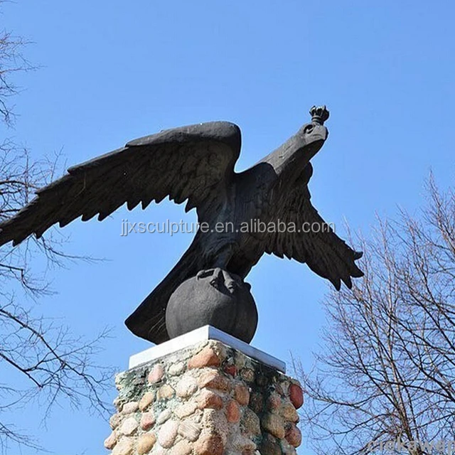 bronze eagle statue with a ball