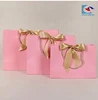 wholesale luxury pink cardboard gift paper bags with gold ribbon and rope