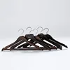 Durable black wooden suit hangers with customized hotel logo