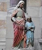 Famous religious figure saint Anne and young girl statue