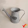 Antique metal water cans with blackboard