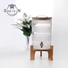clear round glass drinking dispenser with tap /wooden stand