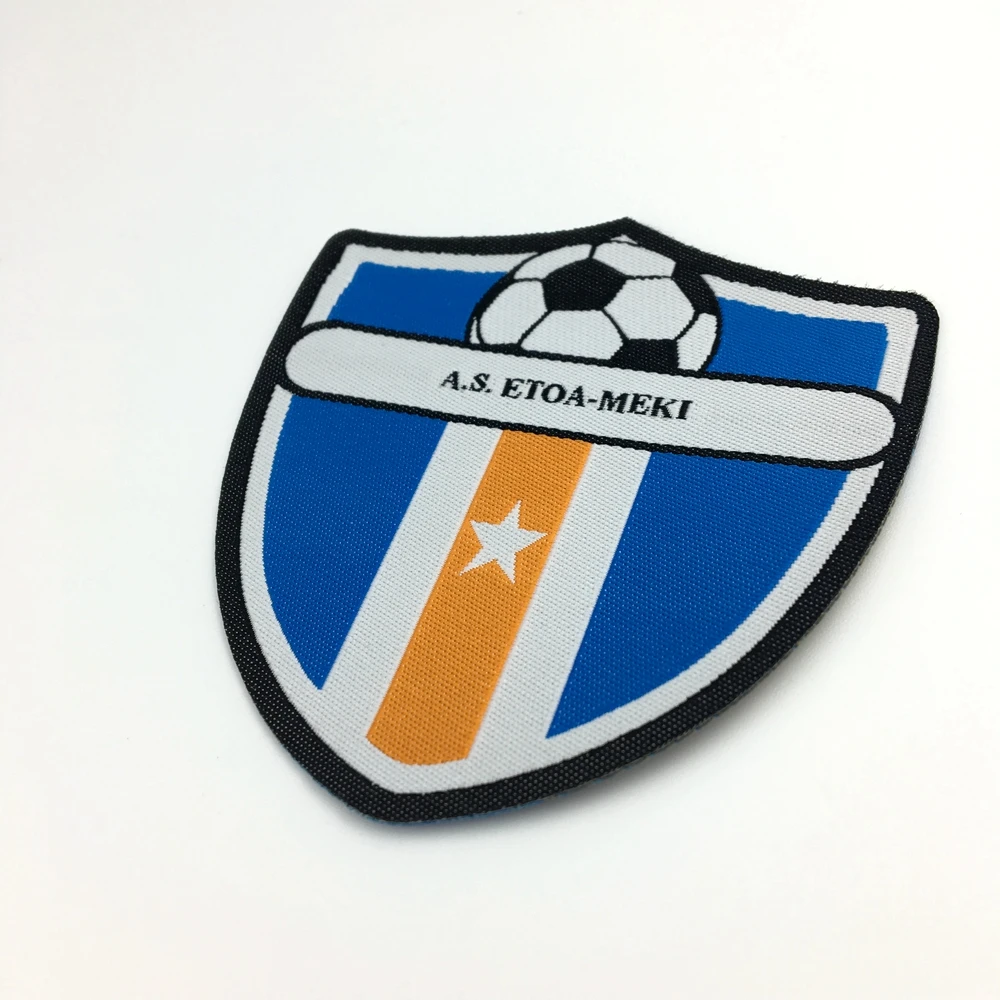 Iron on Custom Soccer Team Name Logo Machine Woven Sport Fabric Patch and Badge for Uniform Clothing
Iron on Custom Soccer Team Name Logo Machine Woven Sport Fabric Patch and Badge for Uniform Clothing