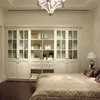 built in white tall bookcase with aluminum glass doors in bedroom
