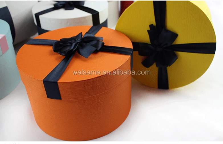 handmade empty small round paper gift box with ribbon.