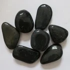 Natural pebbles polished black river rocks
