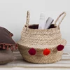 Handmade corn leaf seagrass belly basket with pom pom handles
