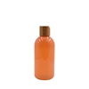 high quality and hot sales cosmetic packaging 100ml 200ml orange pp pet plastic tall shampoo bottle with bamboo disc cap