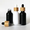 /product-detail/lanjing-hot-selling-1oz-glass-dropper-bottle-30ml-frosted-white-black-glass-bottle-with-bamboo-cap-62400009736.html