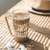 /product-detail/hot-sale-coffee-tea-water-clear-transparent-glass-mug-glass-cup-with-rattan-cup-holder-62388583588.html