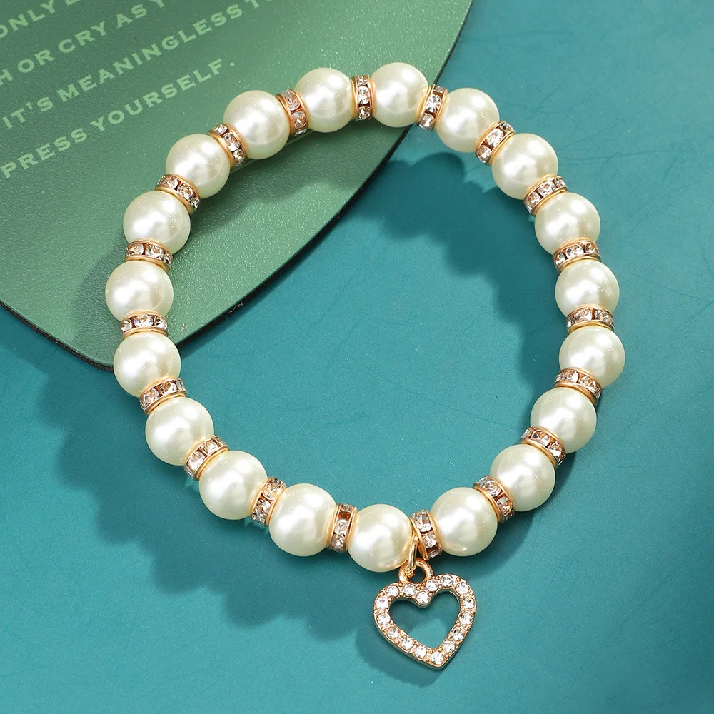 Elegant 18k Gold Plated Septa Hollow Crystal Heart Charm Bracelet Stretch Imitation Pearl Beads Bracelet for women
Elegant 18k Gold Plated Septa Hollow Crystal Heart Charm Bracelet Stretch Imitation Pearl Beads Bracelet for women