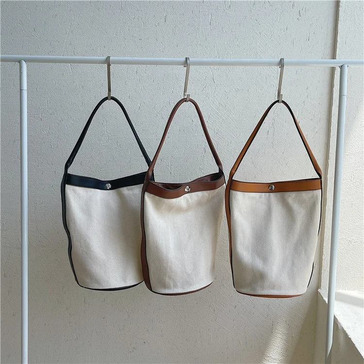 Female student large capacity casual simple canvas bag fashion color popular shoulder bag PU spliced bucket bag
Female student large capacity casual simple canvas bag fashion color popular shoulder bag PU spliced bucket bag