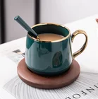 Nordic style cafe used green color glaze ceramic coffee mug with gold handle / wood saucer