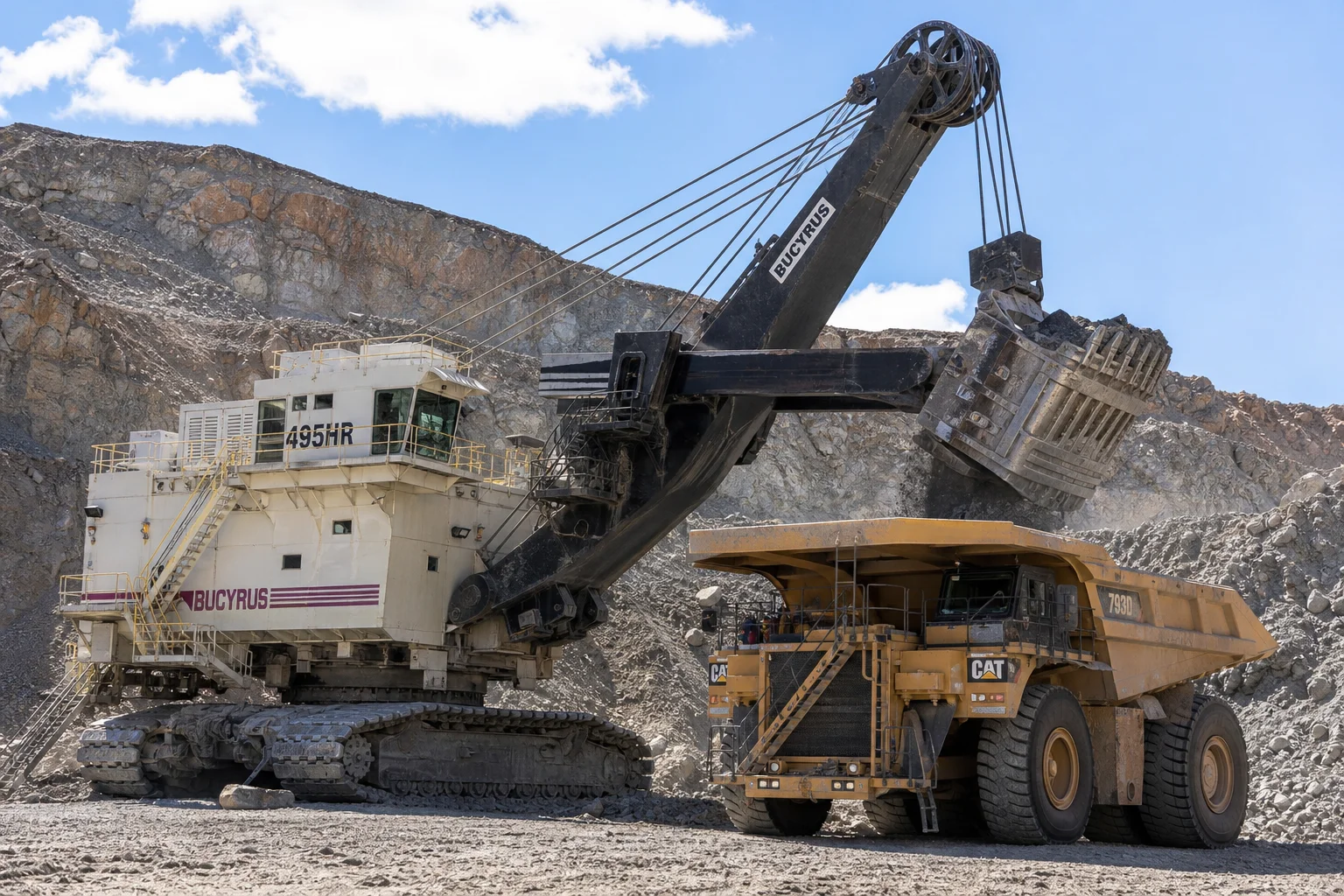 Massive electric rope mining shovel loading haul truck with heavy cast steel track pads and sheaves