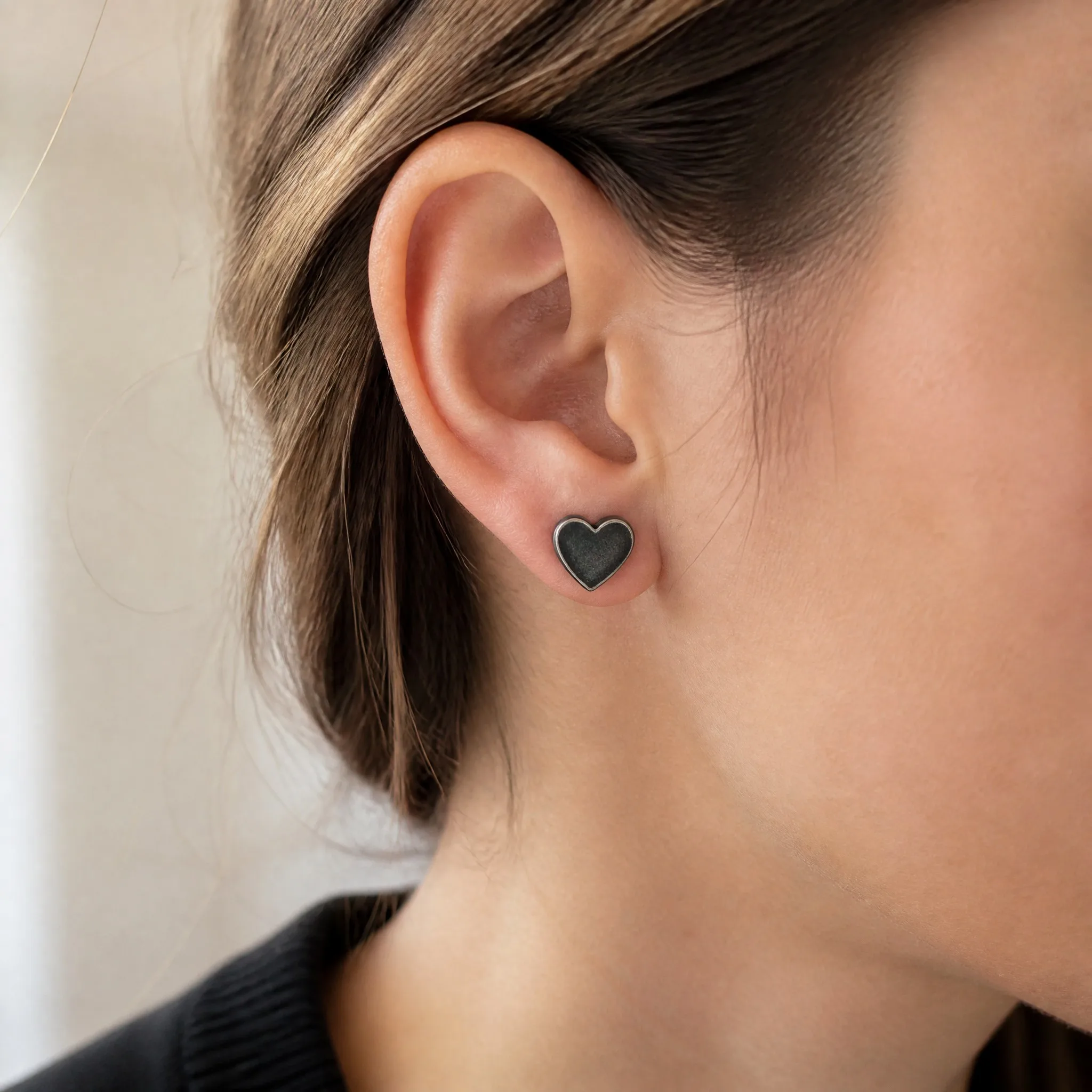 Wearing oxidized black heart earrings