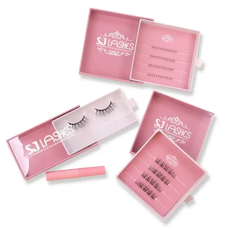 Four pink slide out lash boxes with pull tabs, one open showing a printed insert card with labelled lash rows and another showing a pale tray insert with a lash pair, pink magnetic eyeliner tube - slide out lash box range
