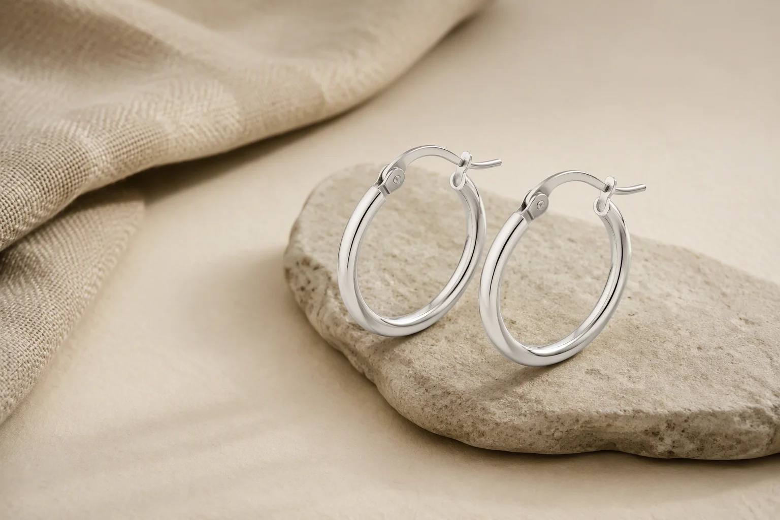 Everyday silver hoop earrings presented as part of a seasonal sterling silver product range