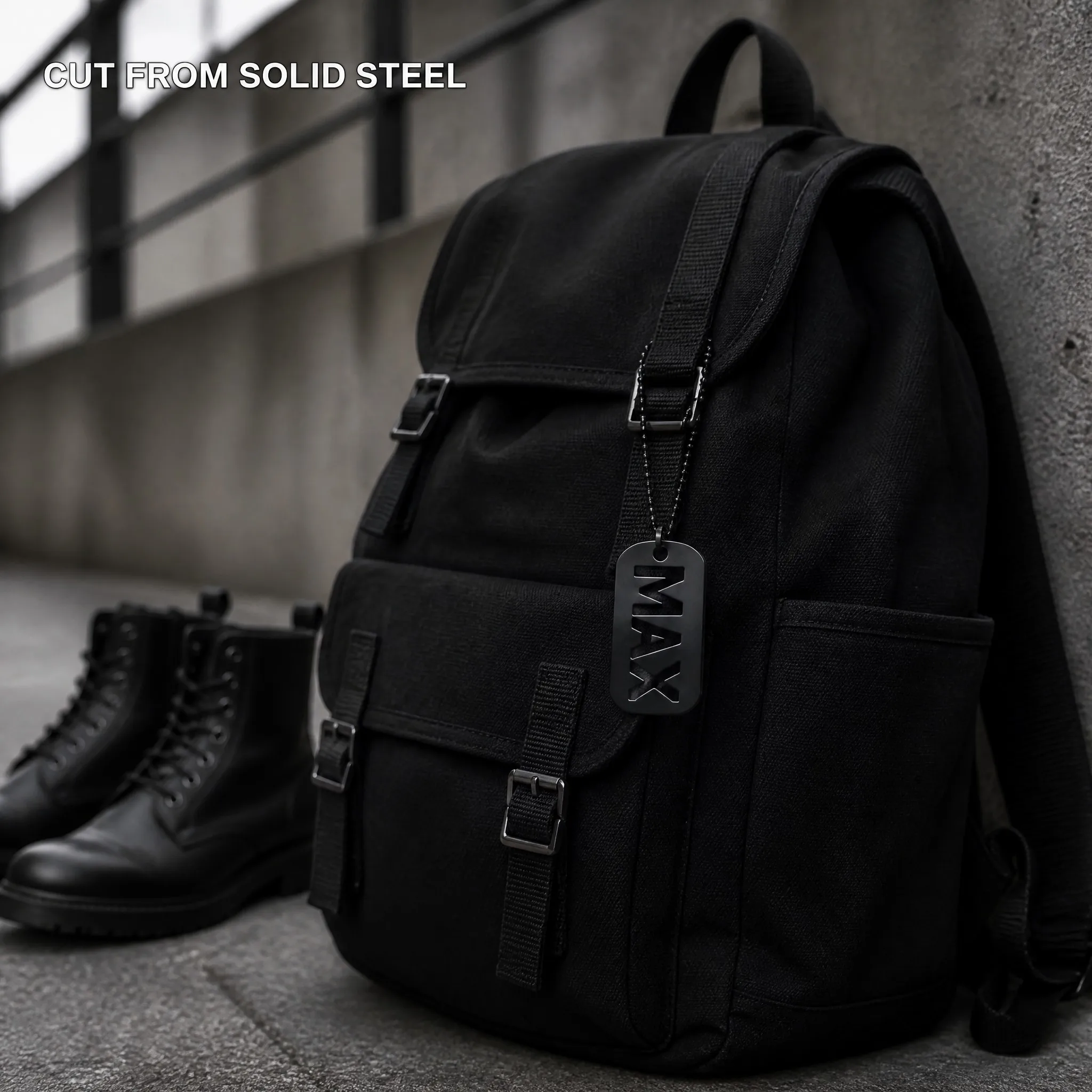 Laser cut dog tag hanging on a black canvas backpack - street scene