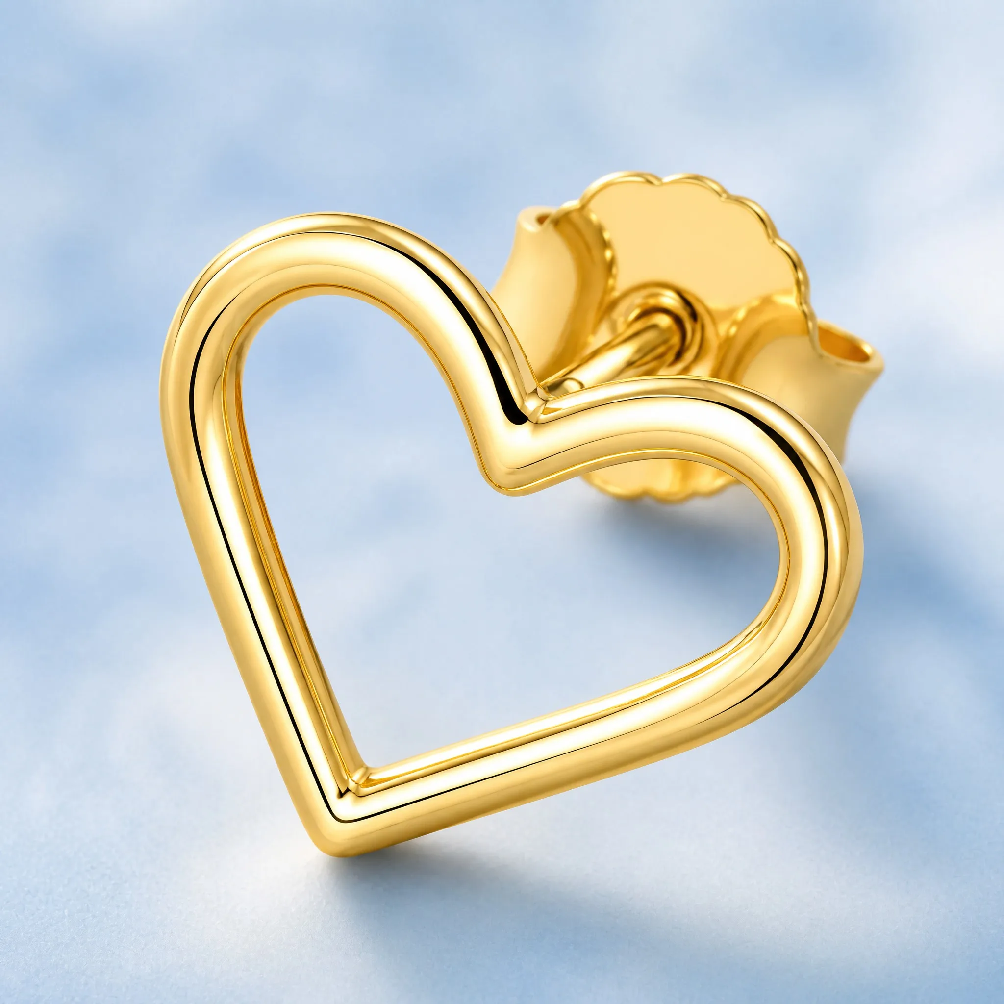 Gold heart earring macro detail