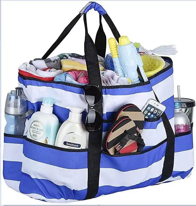 Blue striped multi-pocket beach tote packed with towels, bottles and toys