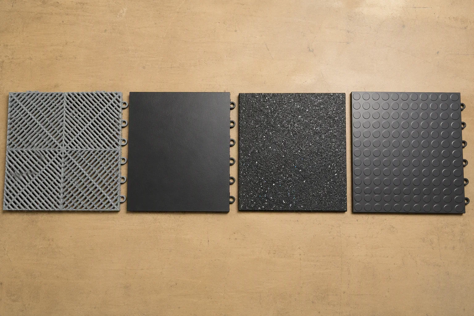 Samples of polypropylene, PVC and rubber garage floor tiles side by side