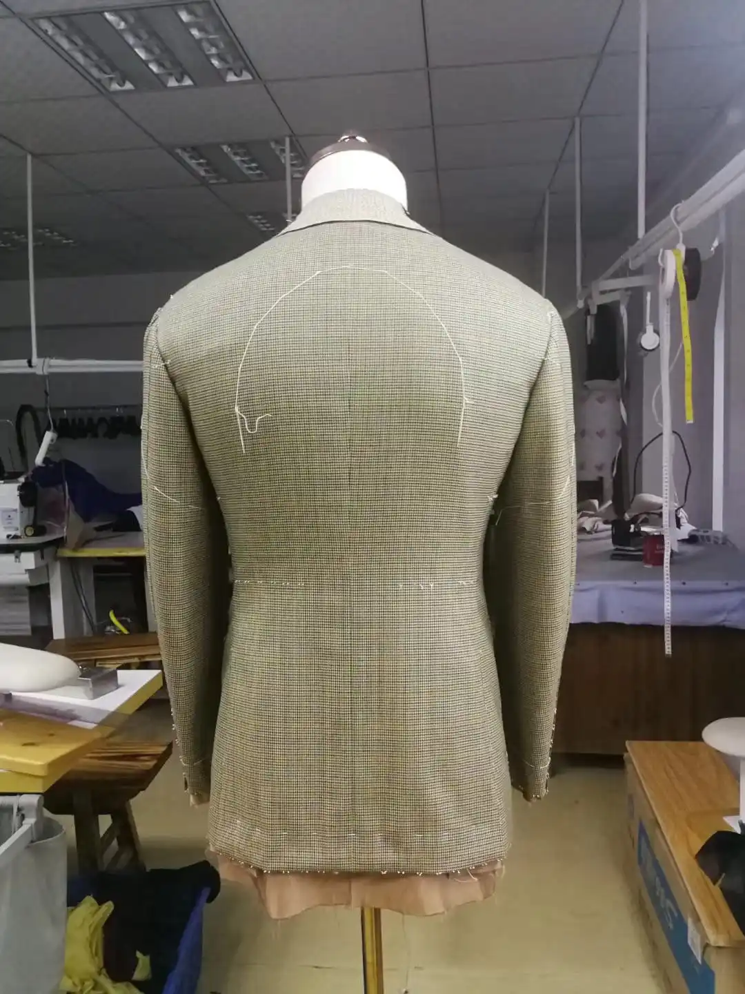 Steam pressing and shaping bespoke suit