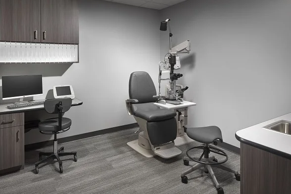 Modern exam room casework with integrated cable management — eliminating the cable forest that occupies up to 20% of lane floor space and creates tripping hazards.