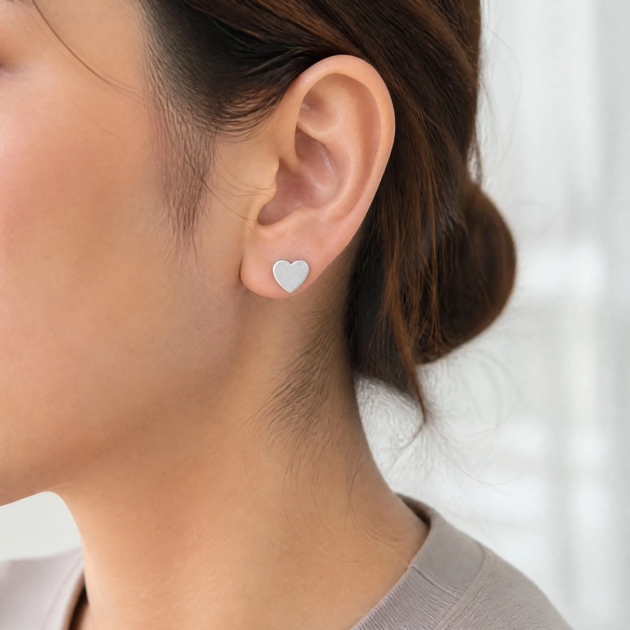 Wearing sandblasted matte heart earrings