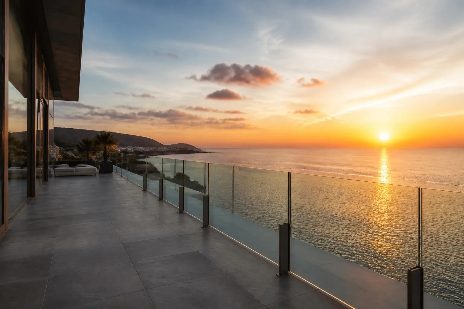 Luxury waterfront villa balcony with frameless aluminum glass railing ocean view sunset