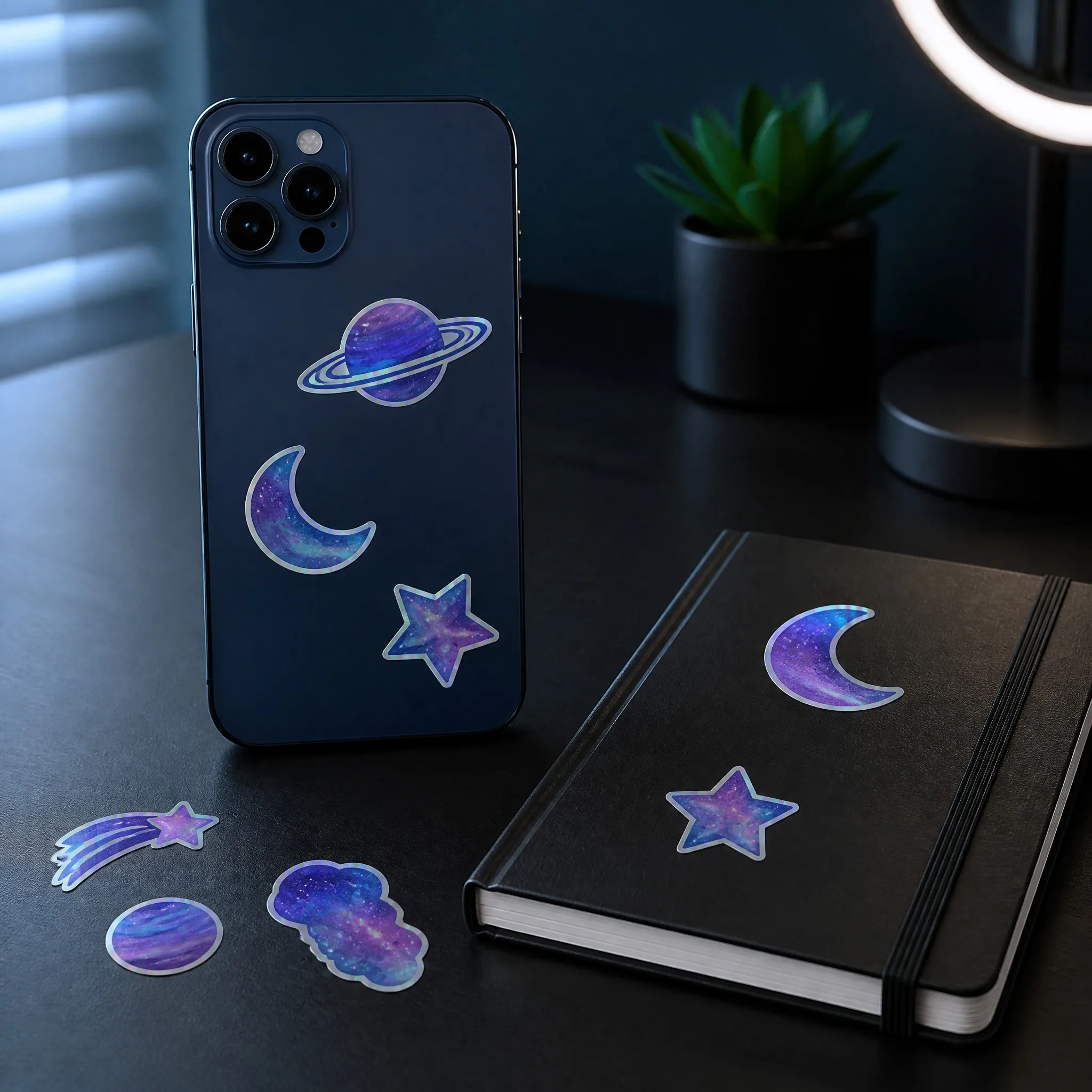Holographic stickers applied on a smartphone and notebook on a dark desk