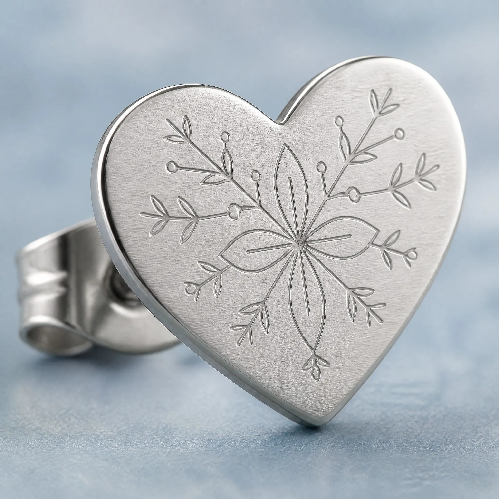 Laser engraved heart earring macro detail
