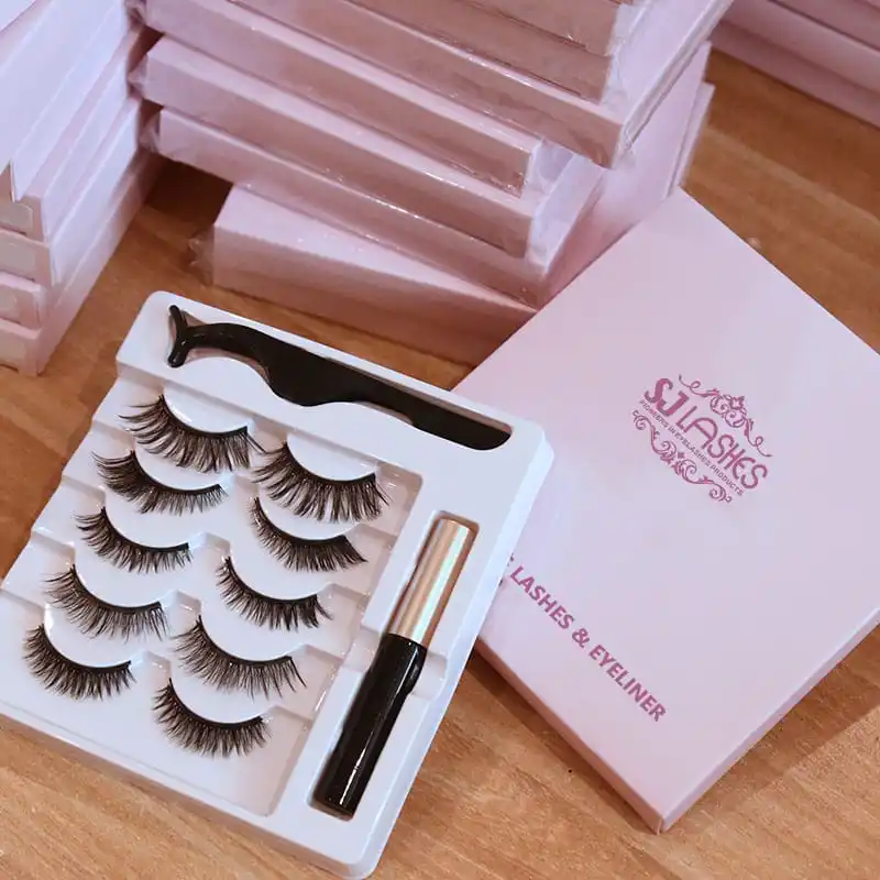 White vacuum formed magnetic lash kit tray with moulded lash pockets, a dedicated applicator recess and a separate channel holding the liner tube - multi material kit tray design
