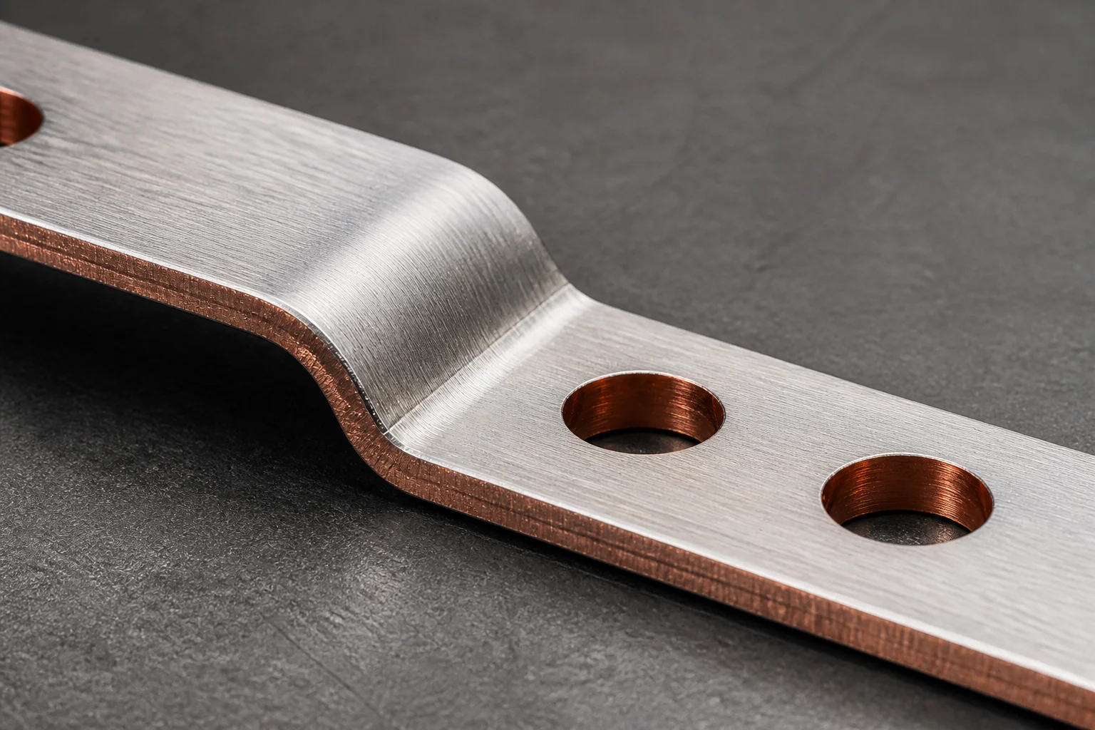 Copper busbar with laser-cut holes and a formed bend