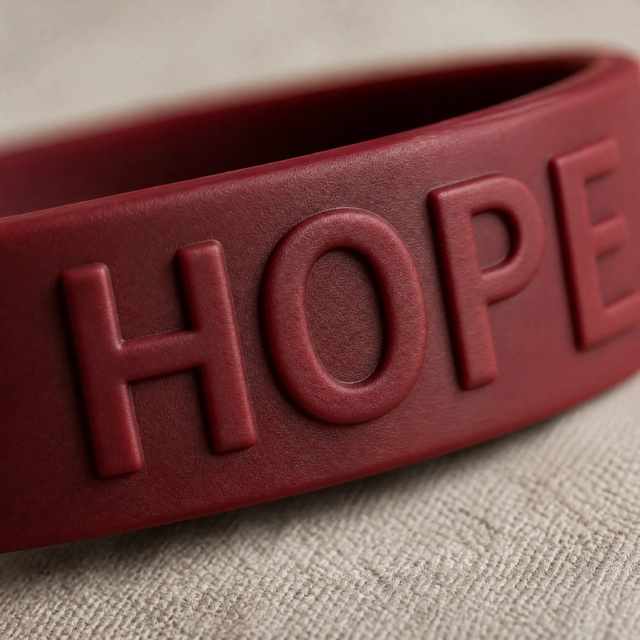 Custom embossed silicone bracelet macro detail of raised lettering