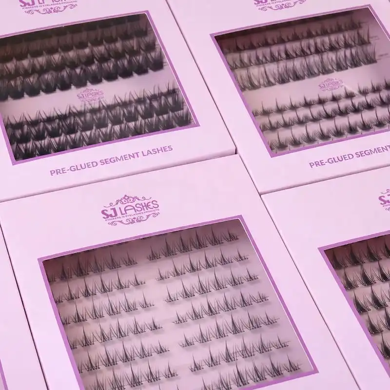 Pale pink boxes for pre-glued segment lashes, eyebrow tint gel and eyebrow gel with a clear glass jar with rose gold lid arranged together - coordinated eye category packaging family