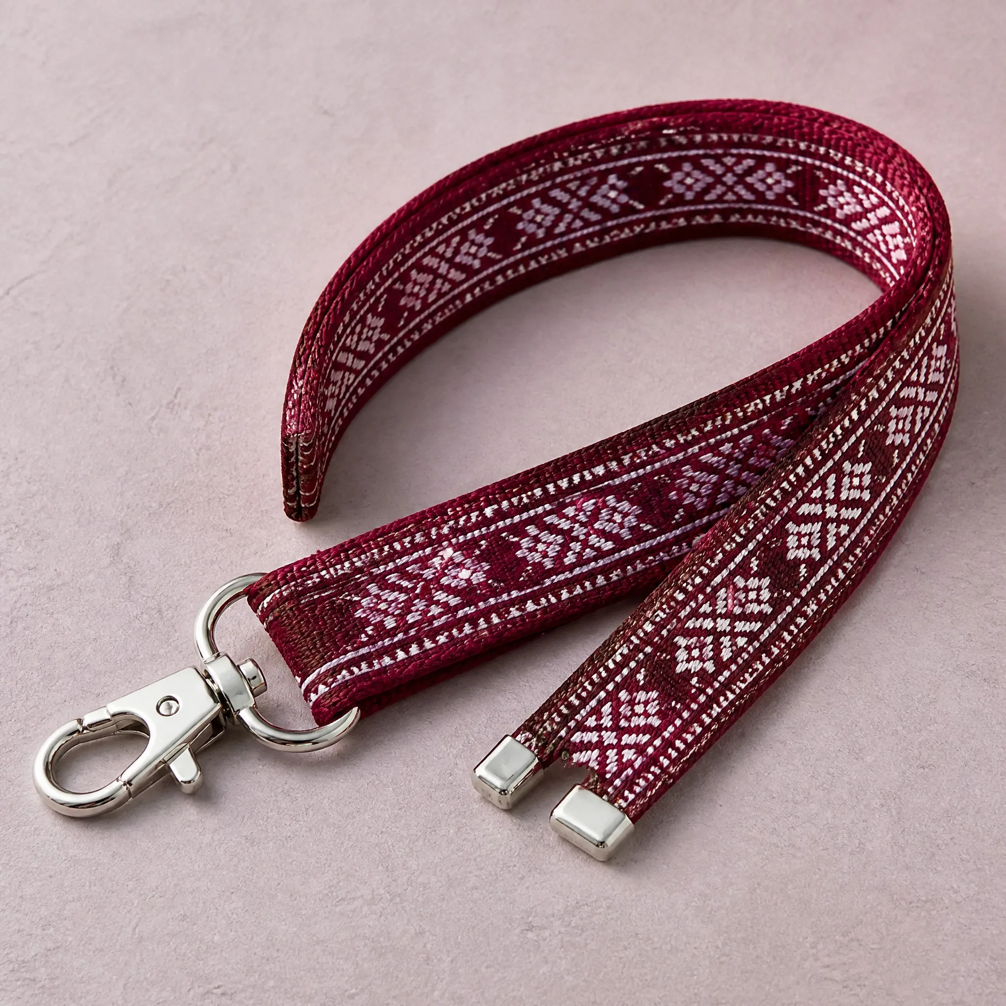 Neat loop of woven lanyard showing metal swivel clip and metal tip ends
