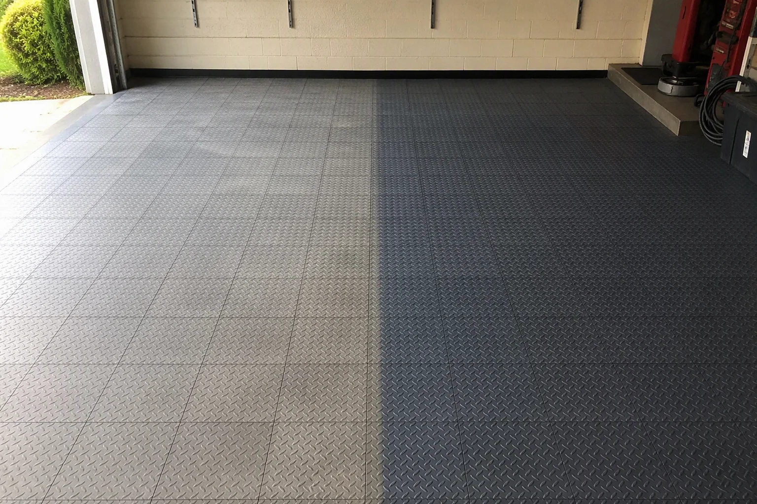 Faded dull garage floor tiles beside a restored section of the same interlocking tile