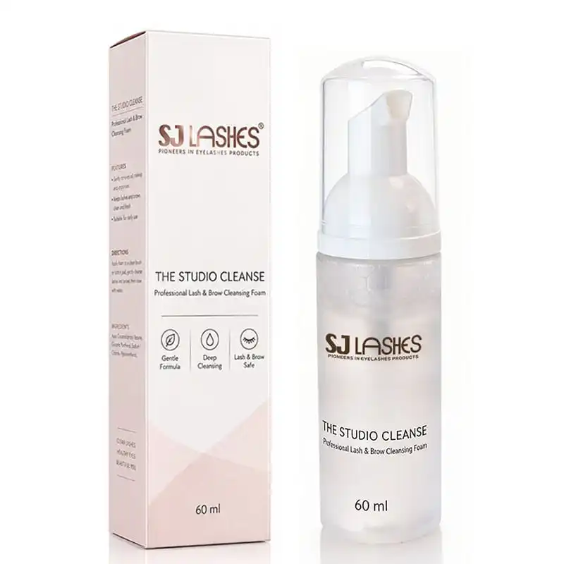 The Studio Cleanse 60ml transparent foam cleanser bottle with white foam pump and clear protective cap beside its matching white paper box printed with purpose, directions and ingredients - custom private label lash cleanser packaging