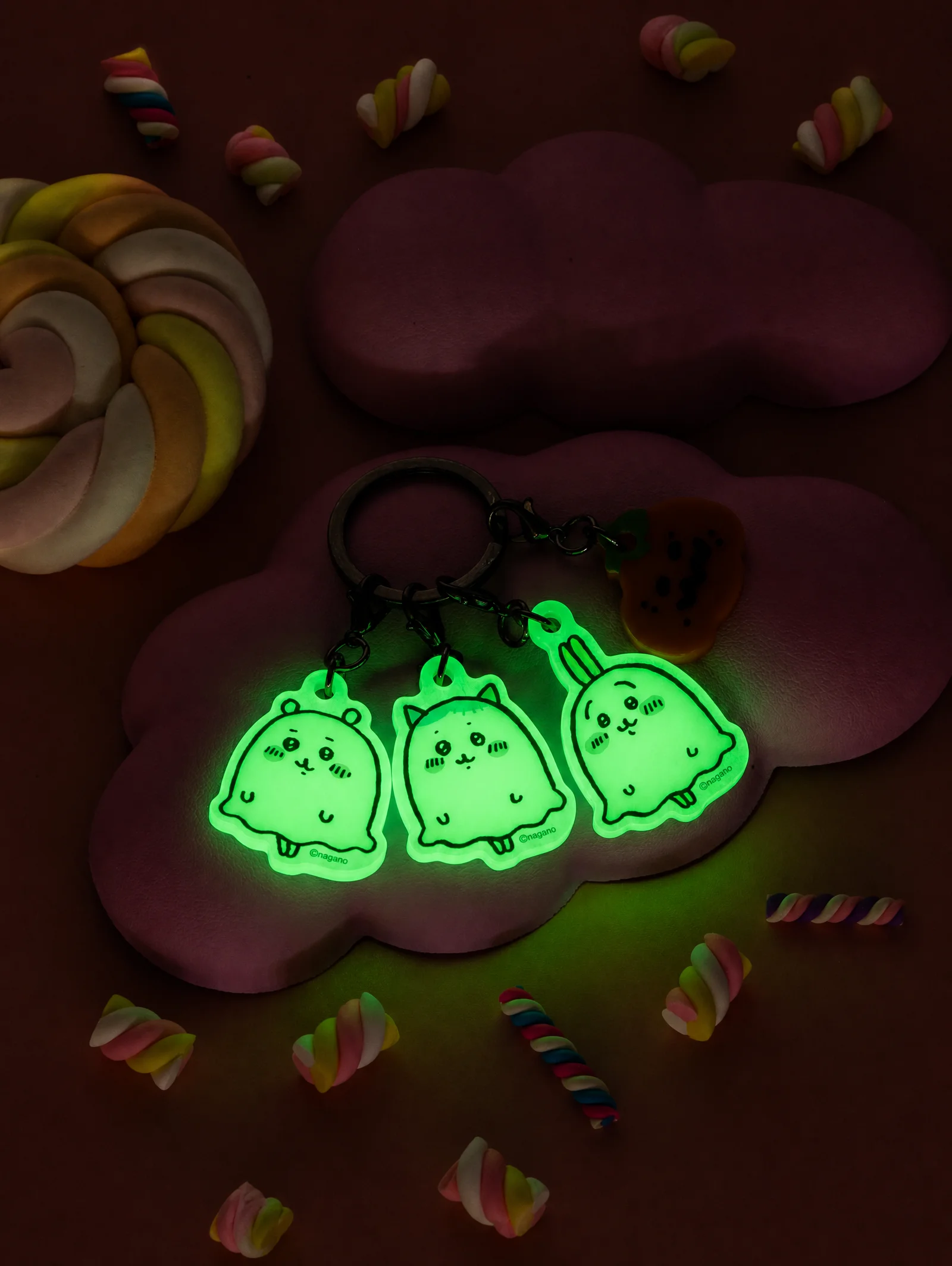 The same Chiikawa Park ghost charm keyring glowing green in the dark