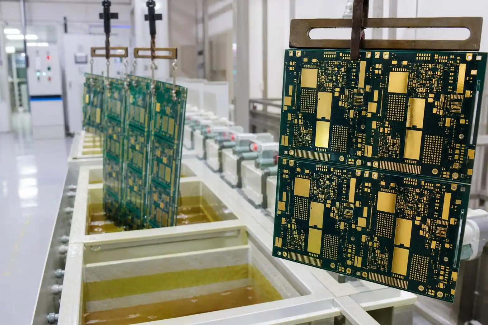 Gold-finished PCB panels hanging on an immersion plating line