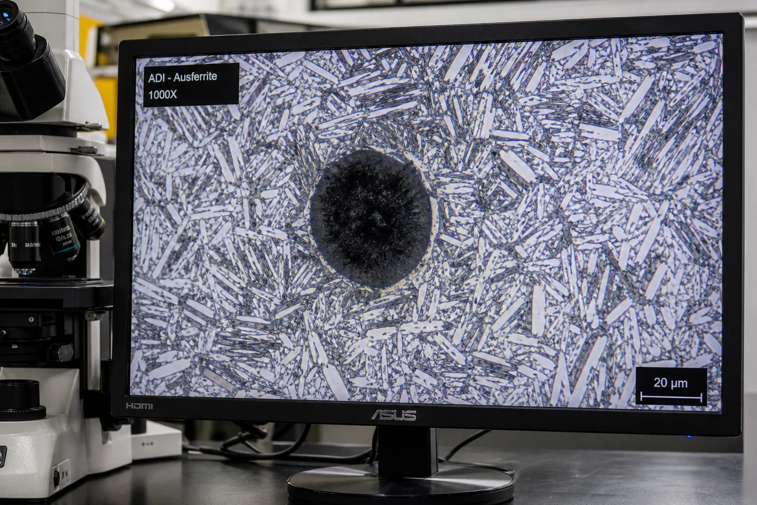 High-magnification metallographic microstructure of ADI ausferrite matrix with graphite nodule
