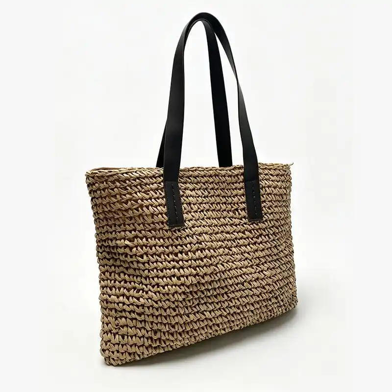 Straw woven tote with black leather handles