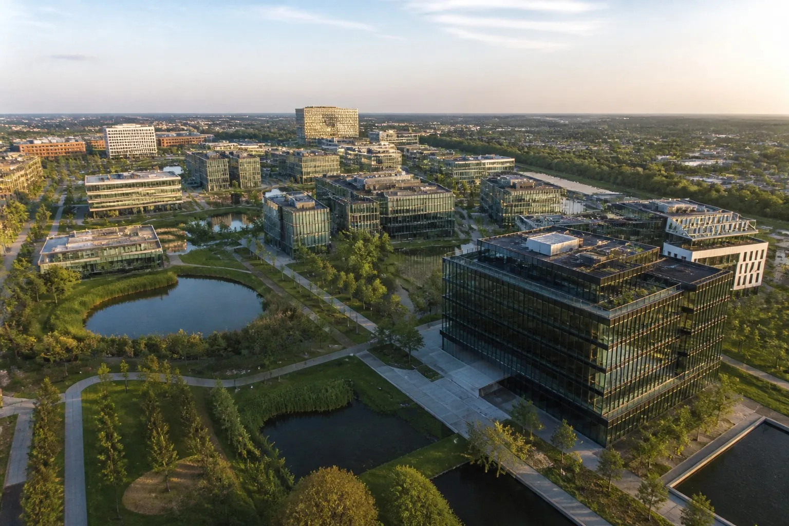 Aerial view of a modern European business park campus with multiple office buildings
