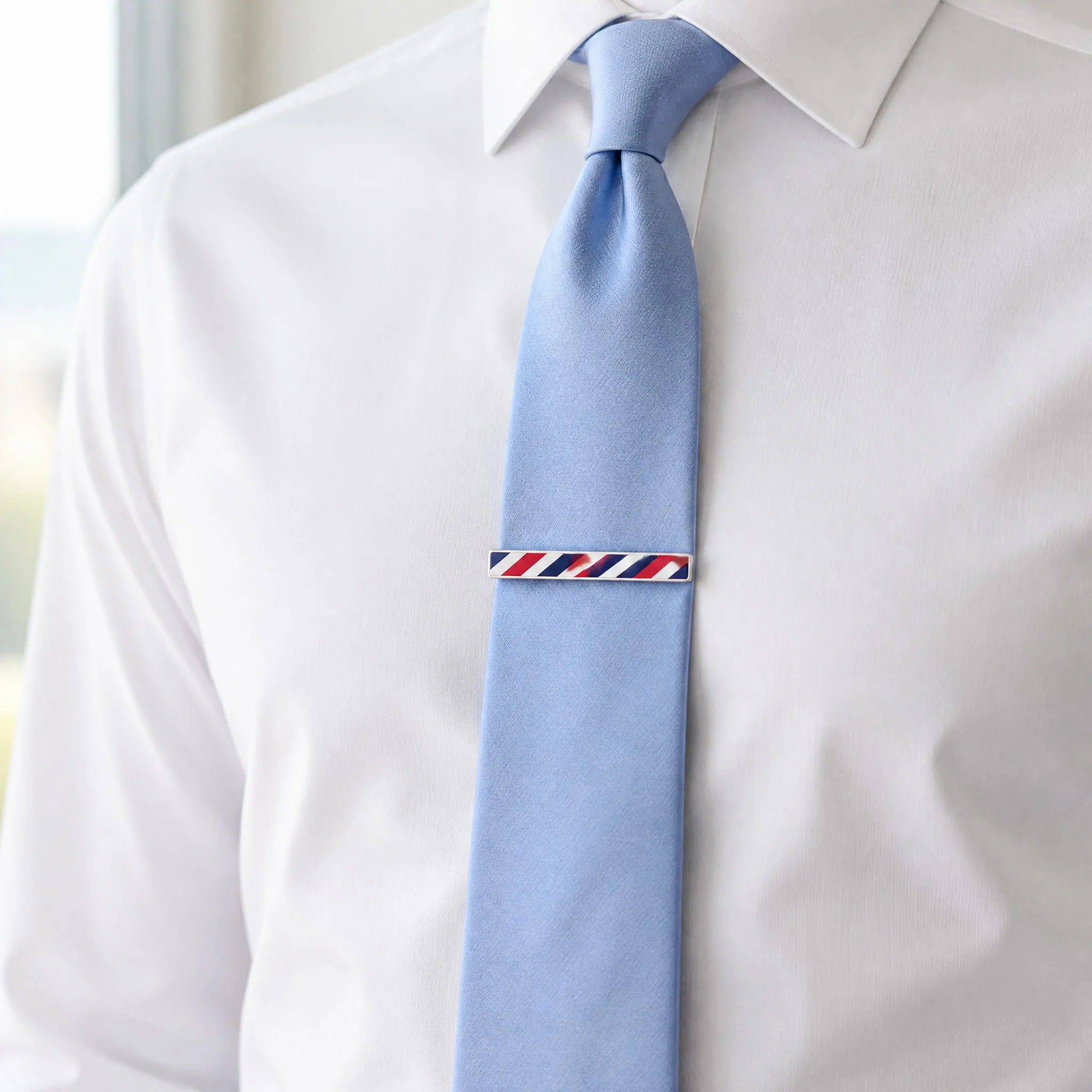 Silk screen printed tie clip worn on light blue silk tie