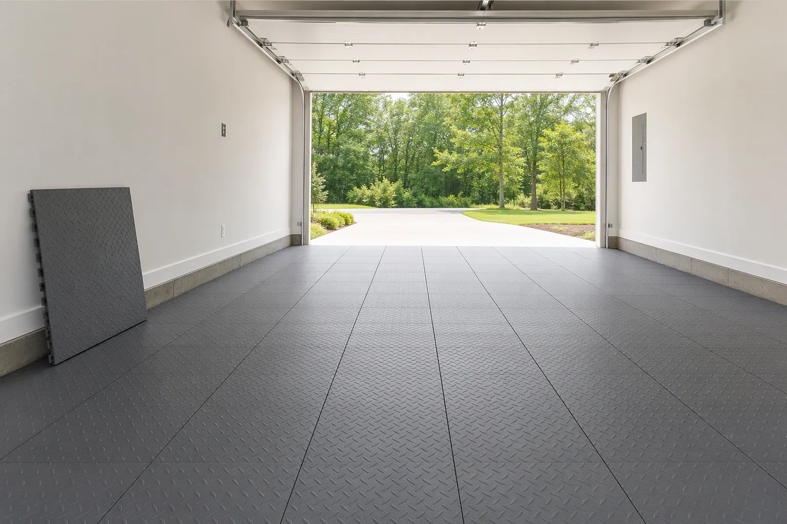 Large rectangular interlocking garage floor tiles laid in straight rows in a two-car garage